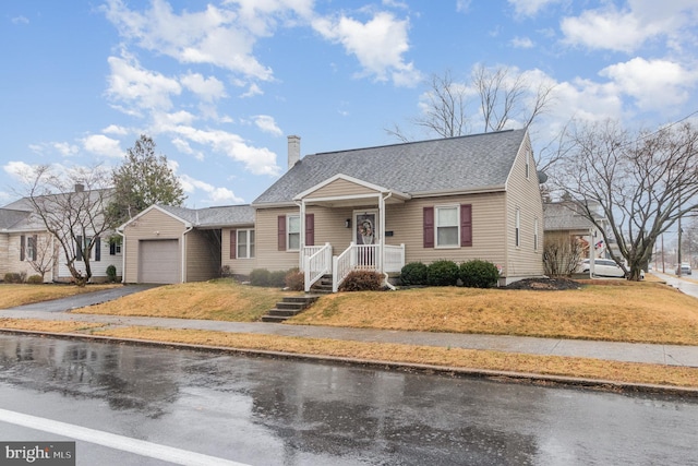 bungalow-style house featuring a chimney, aphalt driveway, roof with shingles, an attached garage, and a front yard