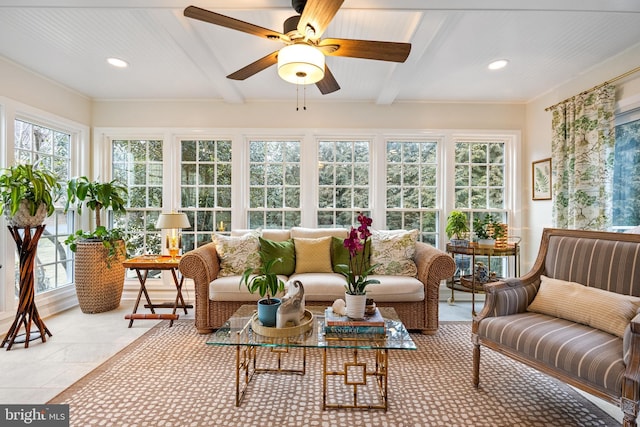 sunroom / solarium with ceiling fan and beam ceiling