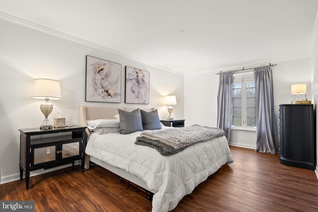 bedroom with ornamental molding, wood finished floors, and baseboards