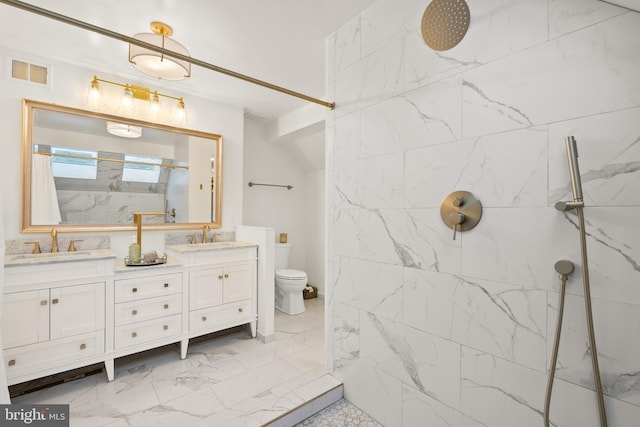 bathroom with marble finish floor, a marble finish shower, double vanity, visible vents, and a sink