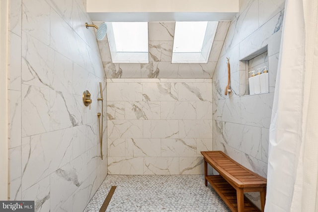 full bath with a skylight and tiled shower