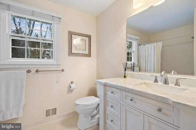 bathroom with visible vents, baseboards, toilet, tile patterned flooring, and vanity