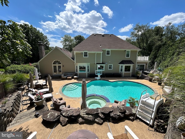 pool with a patio, an outdoor living space, french doors, and an in ground hot tub