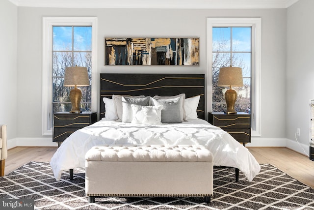 bedroom with wood finished floors and baseboards