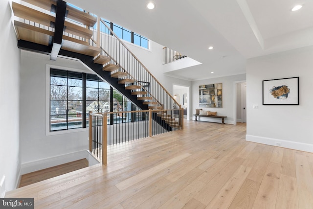 entrance foyer featuring baseboards, hardwood / wood-style floors, recessed lighting, and a healthy amount of sunlight