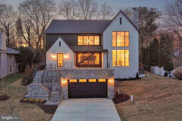 view of front of home featuring an attached garage, concrete driveway, stone siding, stairway, and a chimney