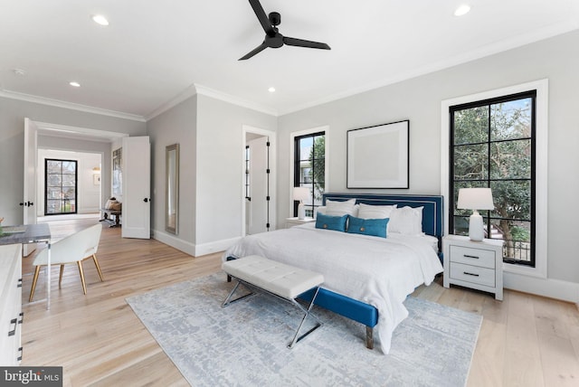 bedroom with light wood-style floors, baseboards, crown molding, and recessed lighting