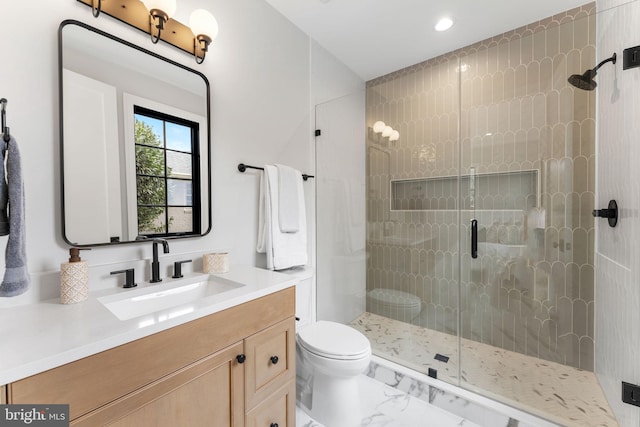 bathroom with toilet, marble finish floor, a shower stall, and vanity