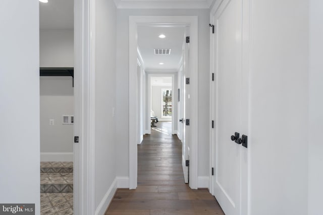 corridor featuring baseboards, wood finished floors, visible vents, and recessed lighting