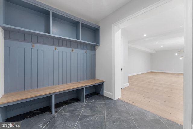 mudroom with dark wood-type flooring, recessed lighting, and baseboards