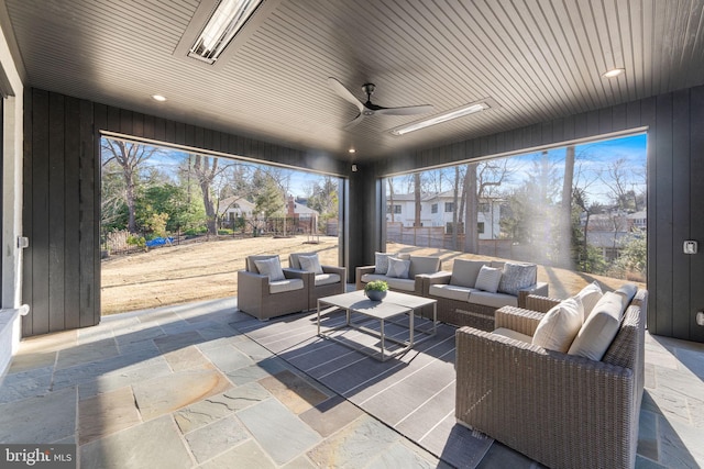 sunroom / solarium featuring ceiling fan and wooden ceiling