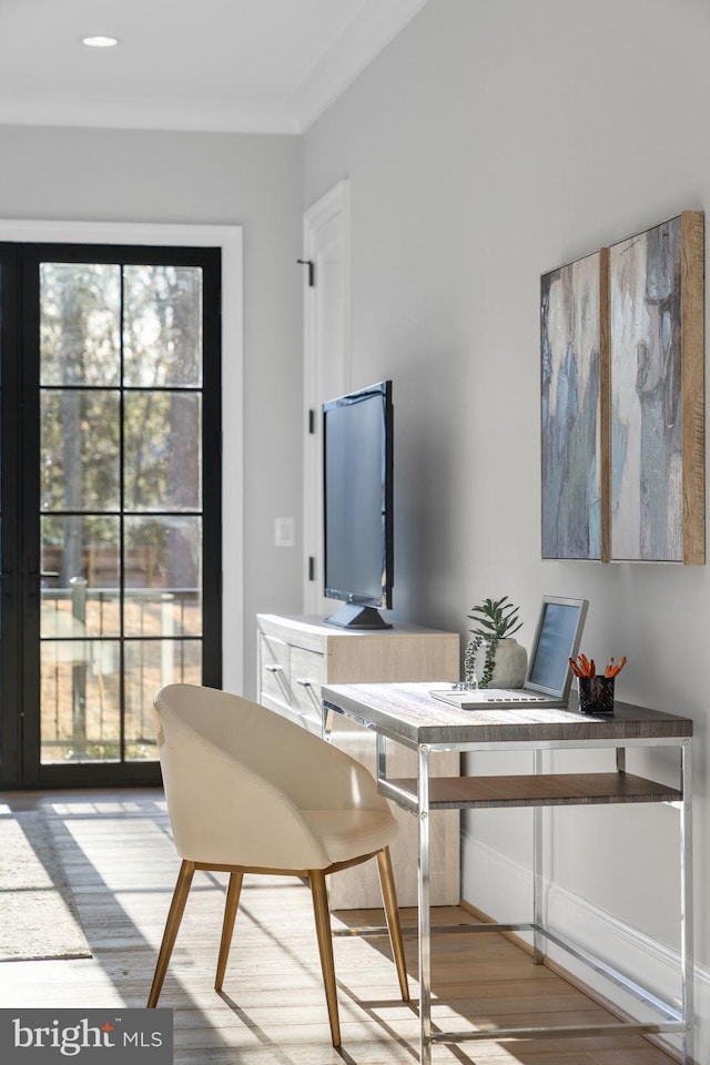 home office with wood finished floors and crown molding