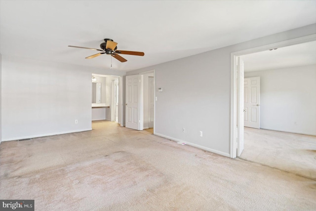 spare room with baseboards, carpet, and a ceiling fan