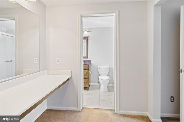 full bathroom with tile patterned floors, toilet, vanity, and baseboards