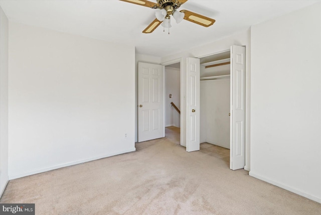 unfurnished bedroom featuring a closet, baseboards, carpet, and ceiling fan