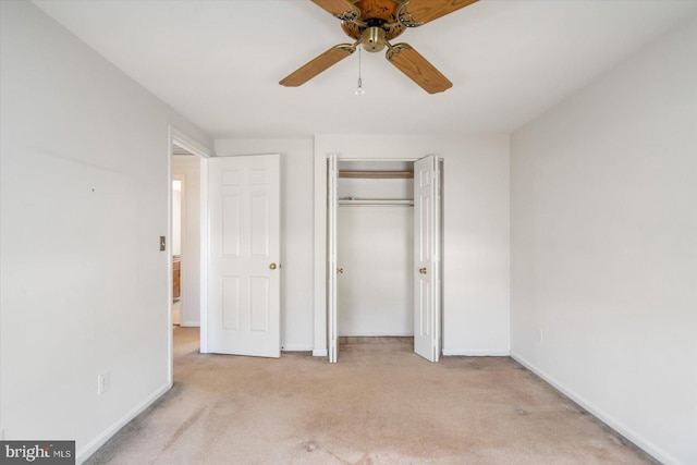 unfurnished bedroom featuring a closet, baseboards, carpet, and a ceiling fan