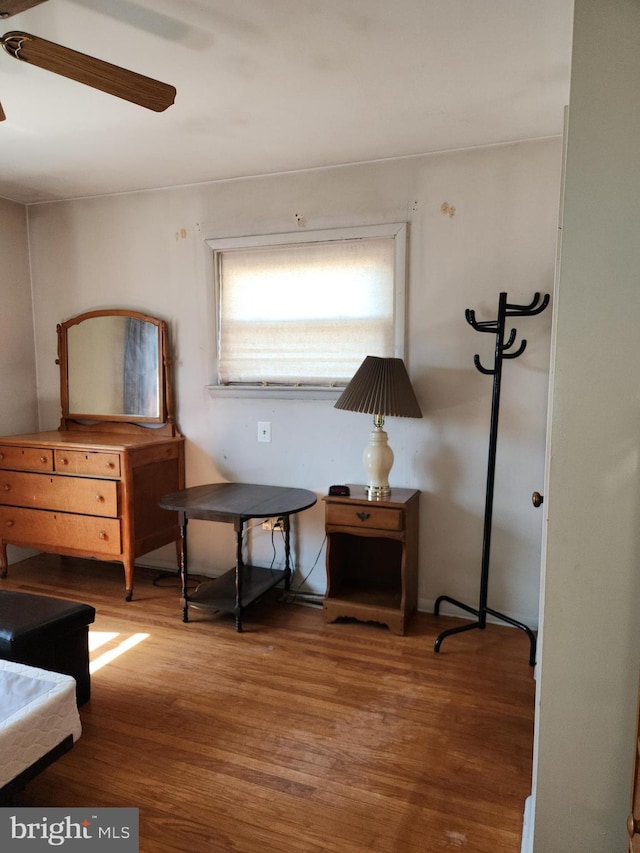 sitting room with wood finished floors and ceiling fan