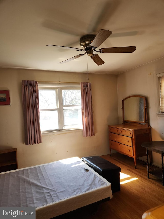 bedroom with ceiling fan and wood finished floors