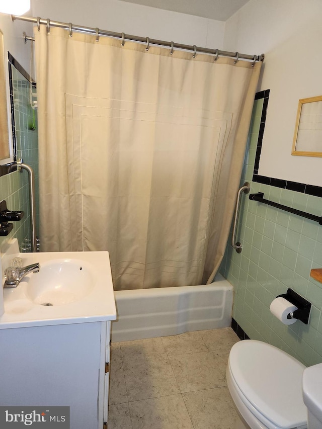 bathroom featuring shower / bathtub combination with curtain, toilet, tile walls, tile patterned flooring, and vanity