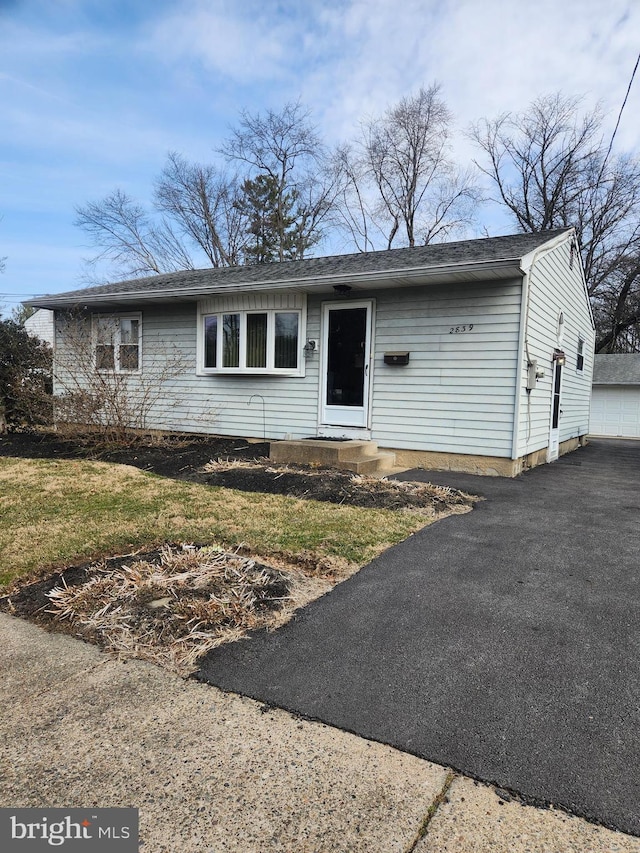 view of front of home with a garage and a front yard