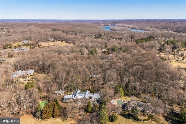 drone / aerial view featuring a water view and a forest view