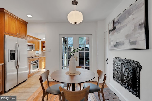 dining area with recessed lighting, french doors, and light tile patterned flooring