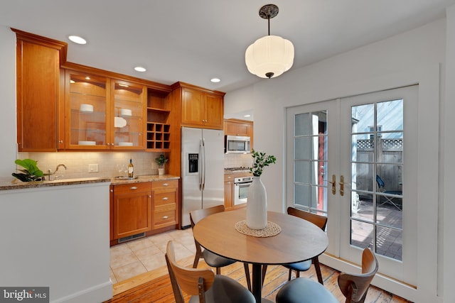 dining area featuring light tile patterned flooring, recessed lighting, and french doors