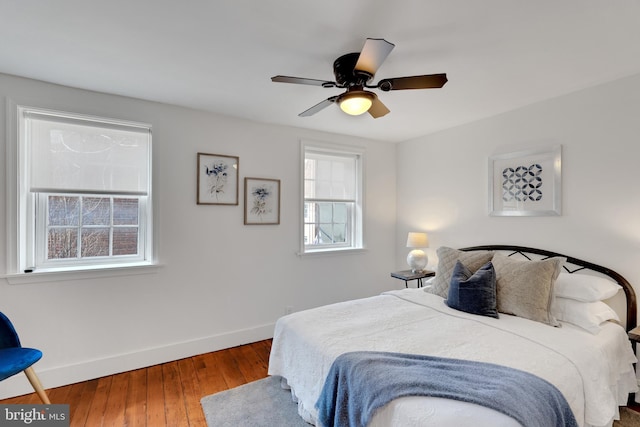 bedroom with hardwood / wood-style flooring, baseboards, and ceiling fan