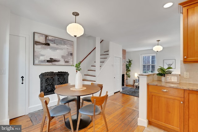 dining area with stairway, recessed lighting, baseboards, and light wood-style floors