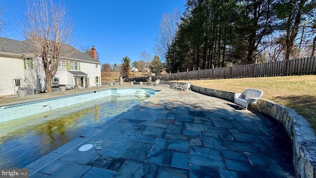 view of swimming pool with a fenced in pool, a lawn, a fenced backyard, and a patio area