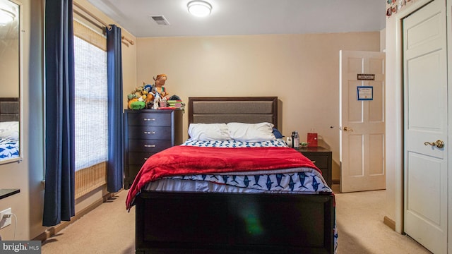 bedroom with visible vents and carpet floors