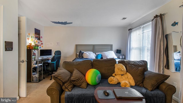 carpeted bedroom featuring visible vents