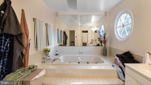 bathroom with a jetted tub and vanity