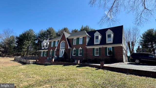 view of front of house with brick siding and a front yard