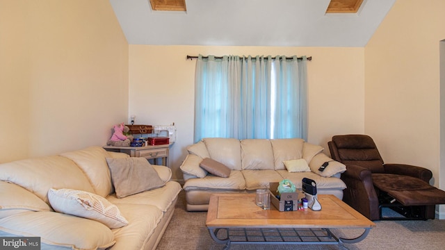 carpeted living room with lofted ceiling