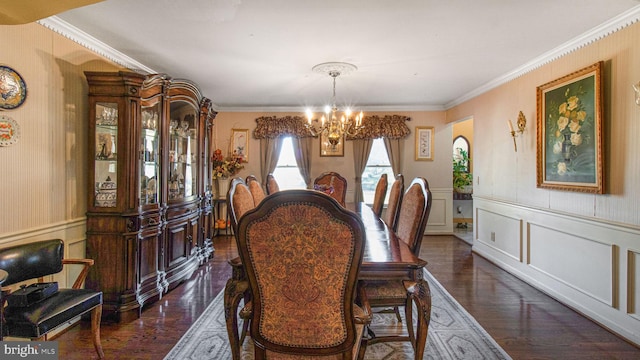 dining room featuring crown molding, a decorative wall, dark wood-style flooring, and a chandelier