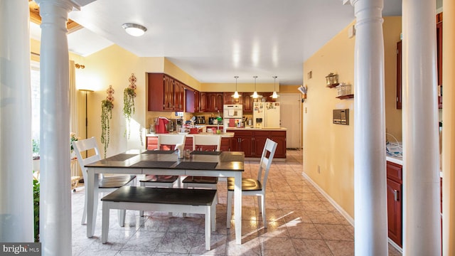 dining area with decorative columns and baseboards