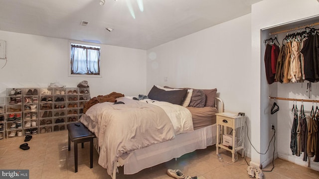 bedroom with light tile patterned floors and visible vents