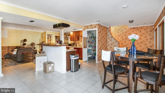 dining space featuring light tile patterned floors, visible vents, and ornamental molding