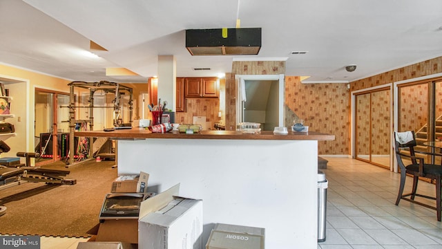 kitchen featuring light tile patterned flooring, visible vents, and ornamental molding