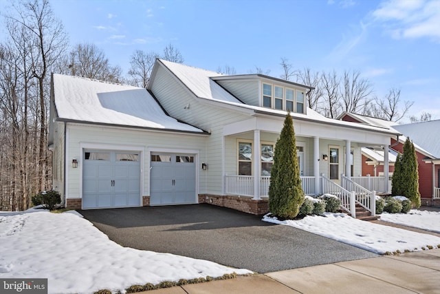 view of front of home with aphalt driveway, a porch, and a garage