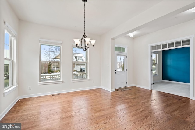 foyer featuring a wealth of natural light, baseboards, and wood finished floors