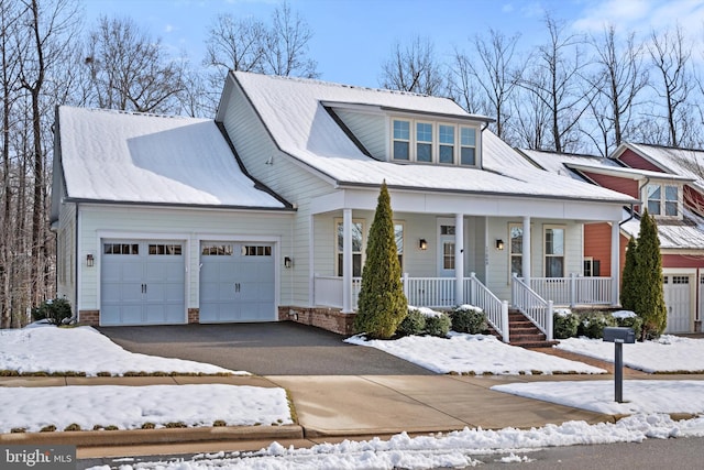 view of front facade featuring a porch, an attached garage, and aphalt driveway