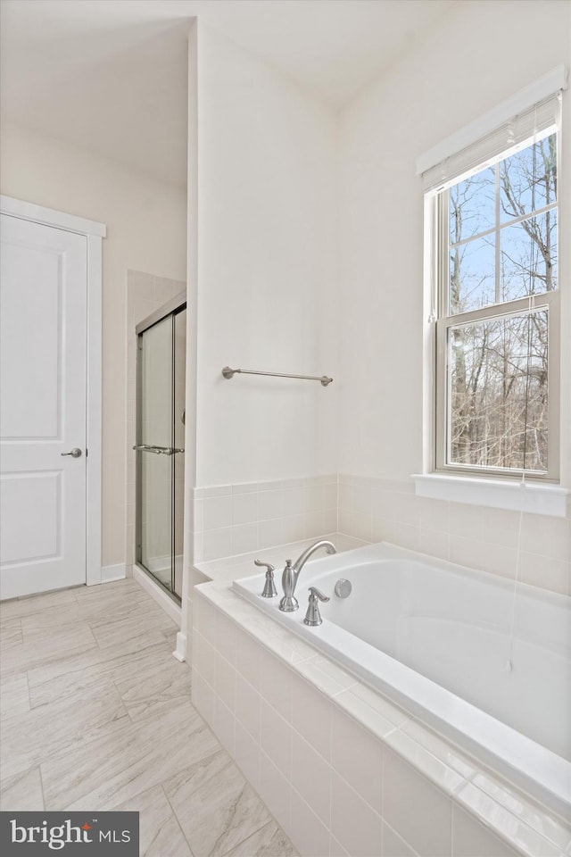 bathroom with a garden tub and a shower stall