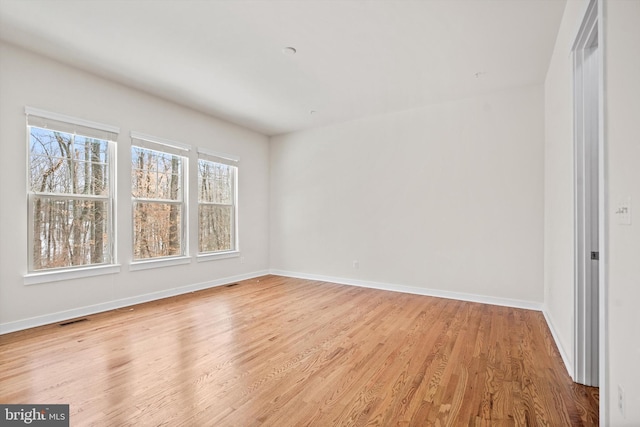 unfurnished bedroom featuring visible vents, light wood-style flooring, and baseboards