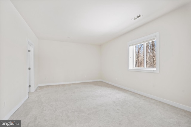 unfurnished room with light carpet, baseboards, and visible vents