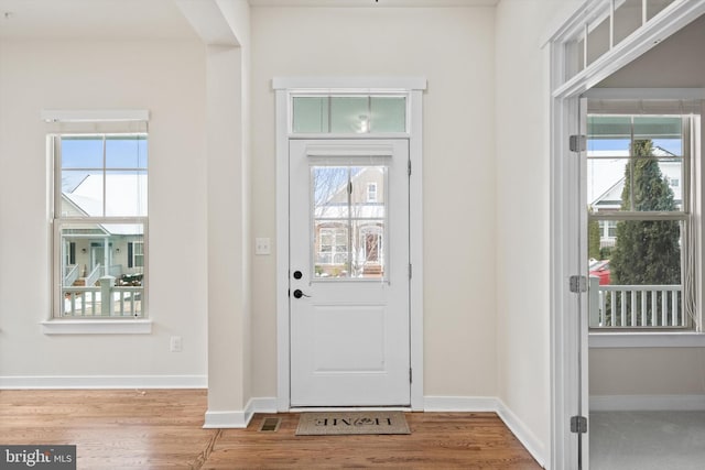 entryway featuring baseboards and wood finished floors