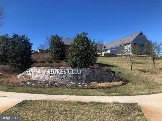 community / neighborhood sign with a yard