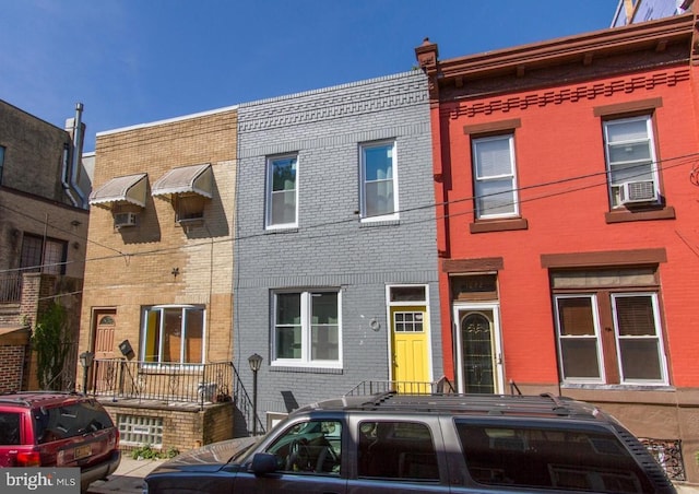 view of property featuring cooling unit and brick siding