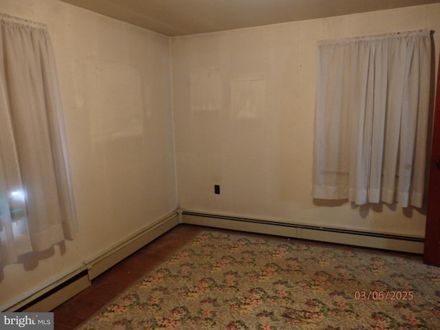 empty room featuring a baseboard heating unit